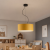 Nowoczesna lampa wisząca dziecięca o średnicy 40 cm z musztardowym abażurem i czarnym przewodem dekoracyjnym. Idealna do pokoju dziecka, wnętrz skandynawskich i premium. Stylowe oświetlenie sufitowe łączące elegancję, funkcjonalność i ciepły klimat.